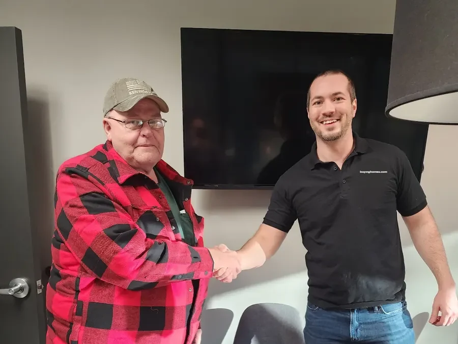 Dan shaking hands with a seller at the title company