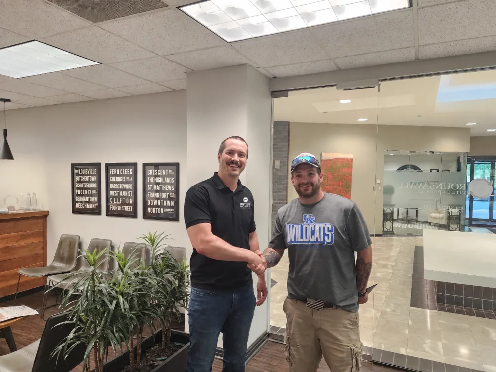 Dan shaking hands with a seller at the title company after closing