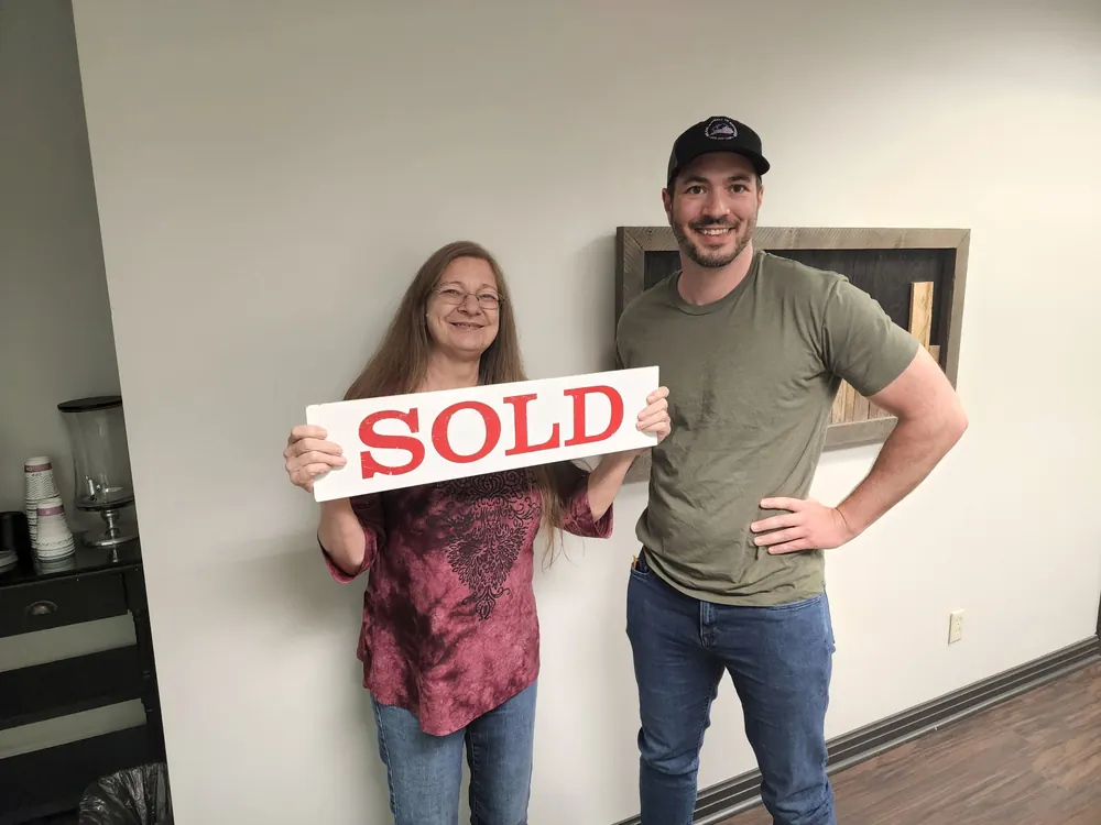 Dan with a seller holding a SOLD sign